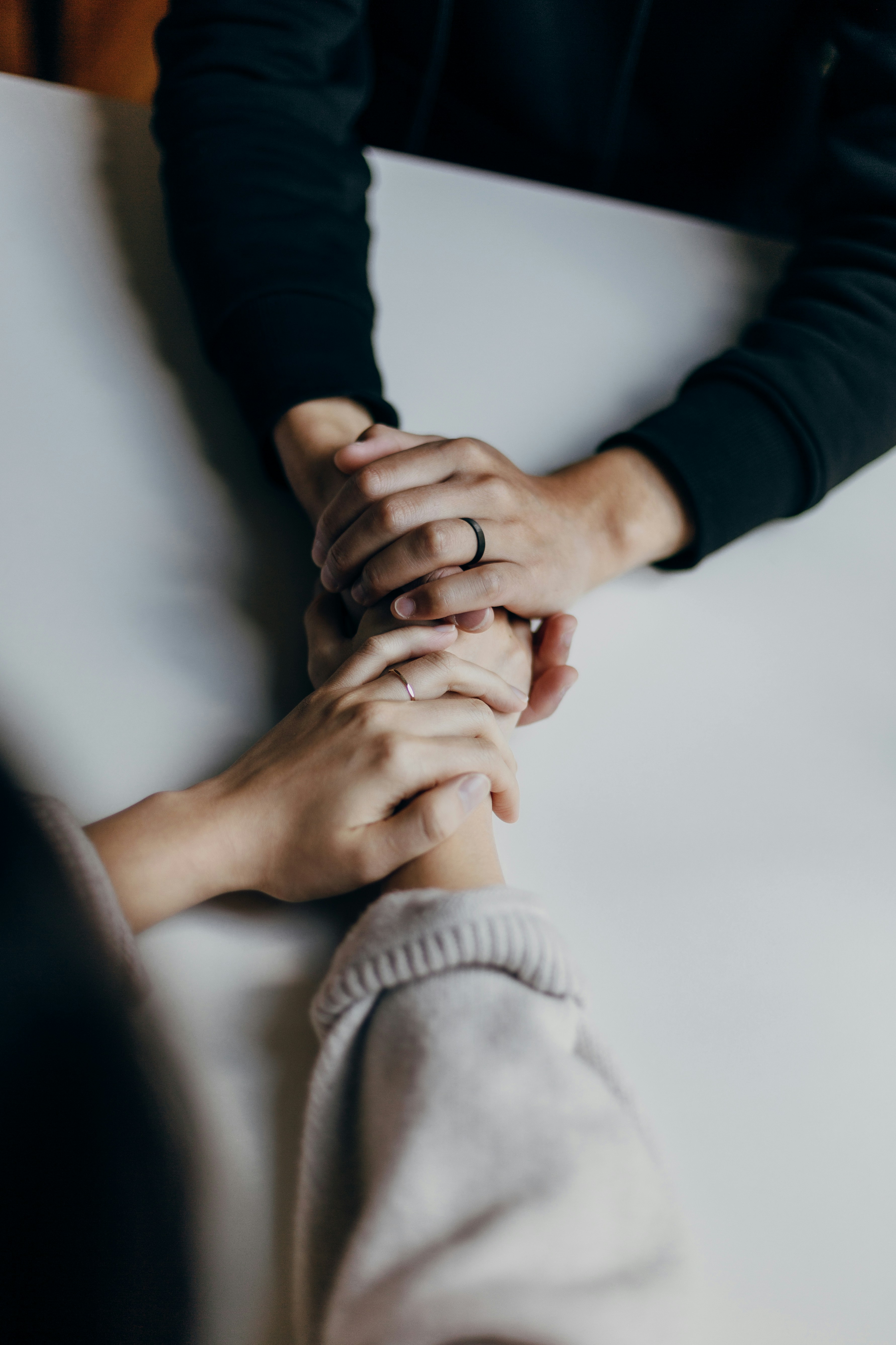Hands clasped together in reassurance